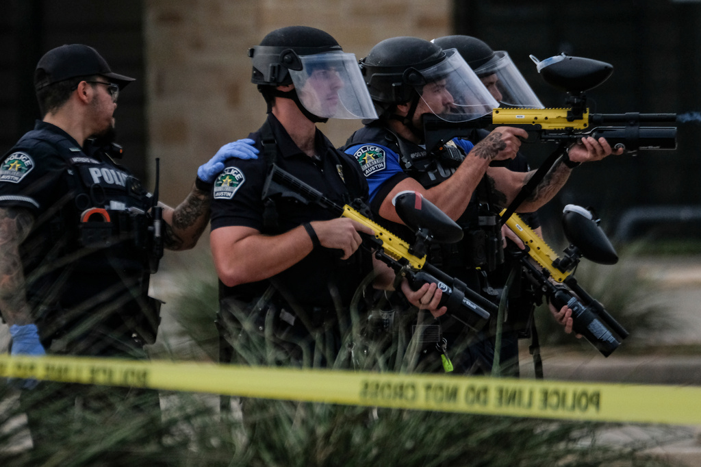 Authorities deploy non-lethan weapons near a demonstration where a man was shot in his vehicle by an ICE officer, Sunday, Sept. 20, 2026, in Austin, Texas. (AP Photo/Joel Angel Juarez)