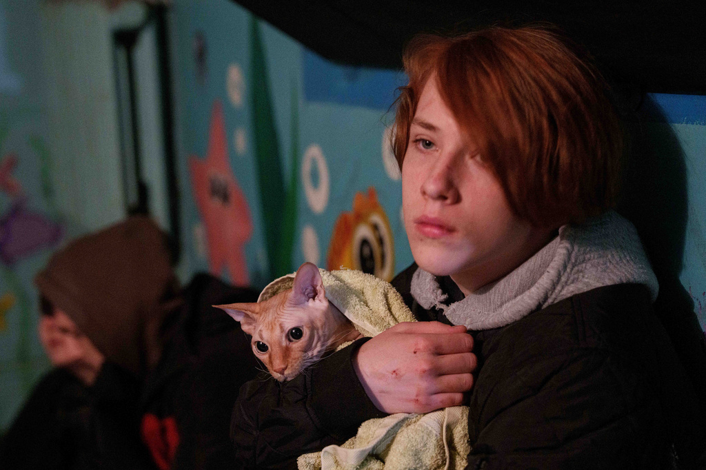 A boy holds his cat as he takes shelter inside a house damaged after a Russian strike on residential neighbourhood in Kyiv, Ukraine, on Thursday, April 16, 2026. (AP Photo/Evgeniy Maloletka)