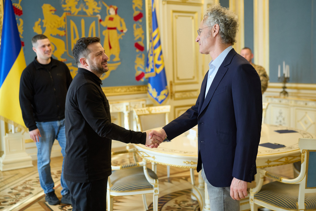 In this photo provided by the Ukrainian Presidential Press Office, Ukrainian President Volodymyr Zelenskyy, left, shakes hands with US businessman and СЕО Palantir Technologies, Alexander Karp in Kyiv, Ukraine, Tuesday, May 12, 2026. (Ukrainian Presidential Press Office via AP)
