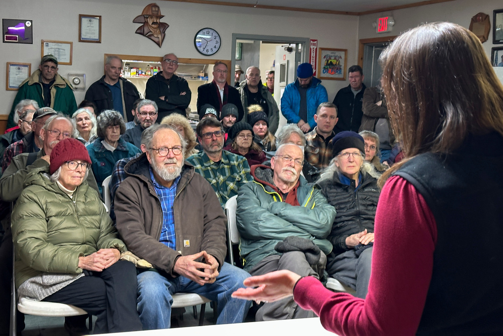 Residents of Lewis, N.Y, attend a public presentation about a proposal to establish a howitzer testing range in the Adirondacks in Lewis, N.Y., Monday, Feb. 2, 2026. (AP Photo/Michael Hill)