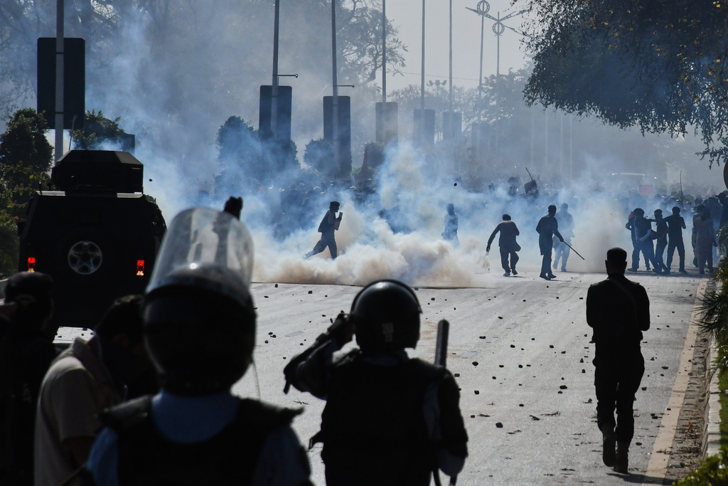 Police officers fire tear gas shells to disperse Shiite Muslims marching toward U.S. Embassy during a rally to condemn the killing of Iranian Supreme Leader Ayatollah Ali Khamenei, in Islamabad, Pakistan, Sunday, March 1, 2026. (AP Photo/M.A. Sheikh)