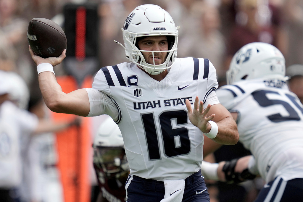 Utah State quarterback Bryson Barnes (16) looks to pass during the first quarter of an NCAA college football game against Texas A&M on Saturday, Sept. 6, 2025, in College Station, Texas. (AP Photo/Sam Craft)