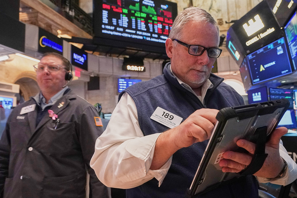 Trader Michael Conlon, right, works on the floor of the New York Stock Exchange, Thursday, Feb. 5, 2026. (AP Photo/Richard Drew)