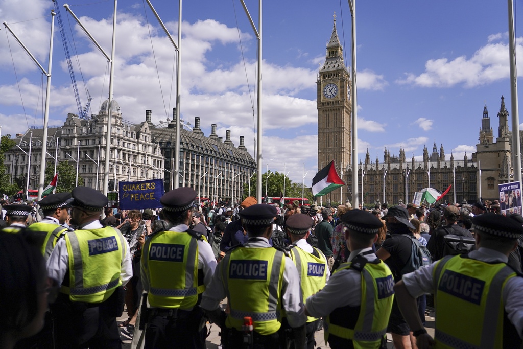 Police officers patrol during demonstrator during a protest in support of the Palestinian People in Gaza, in Parliament Square, in London, Saturday, Aug. 9, 2025.(AP Photo/Alberto Pezzali)
