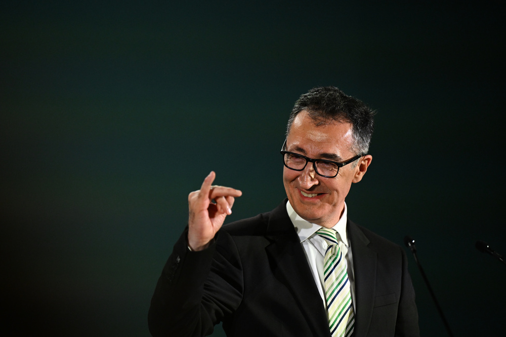 Cem Özdemir (Alliance 90/The Greens), top candidate in the Baden-Württemberg state elections, makes a gesture at his party's election party and stretches up the little finger of his right hand, in Stuttgart, Germany, Sunday, March 8, 2026. (Bernd Weißbrod/dpa via AP)