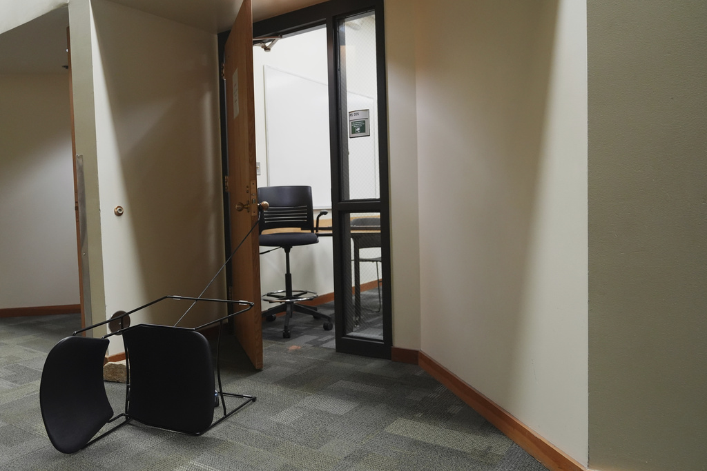 A chair is tied to a door from a classroom a day after the shooting of Charlie Kirk at Utah Valley University in Orem, Utah, Thursday, Sept. 11, 2025. (AP Photo/Lindsey Wasson)