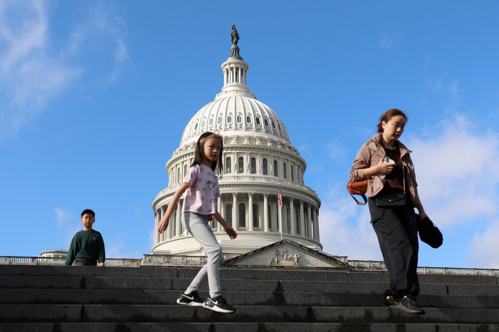 Visitors walk the steps in front of the the U.S. Capitol, Wednesday, Nov. 26, 2025, in Washington. (AP Photo/Rahmat Gul)