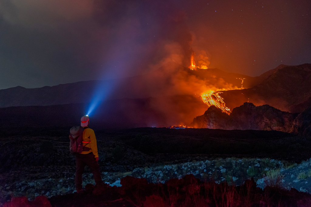Eruptive activity continues on Mount Etna, where lava flows continue to descend on the slopes of the volcano, as seen from Mareneve near Catania, Italy, Thursday, Aug. 13, 2026. (AP Photo/Salvatore Allegra)