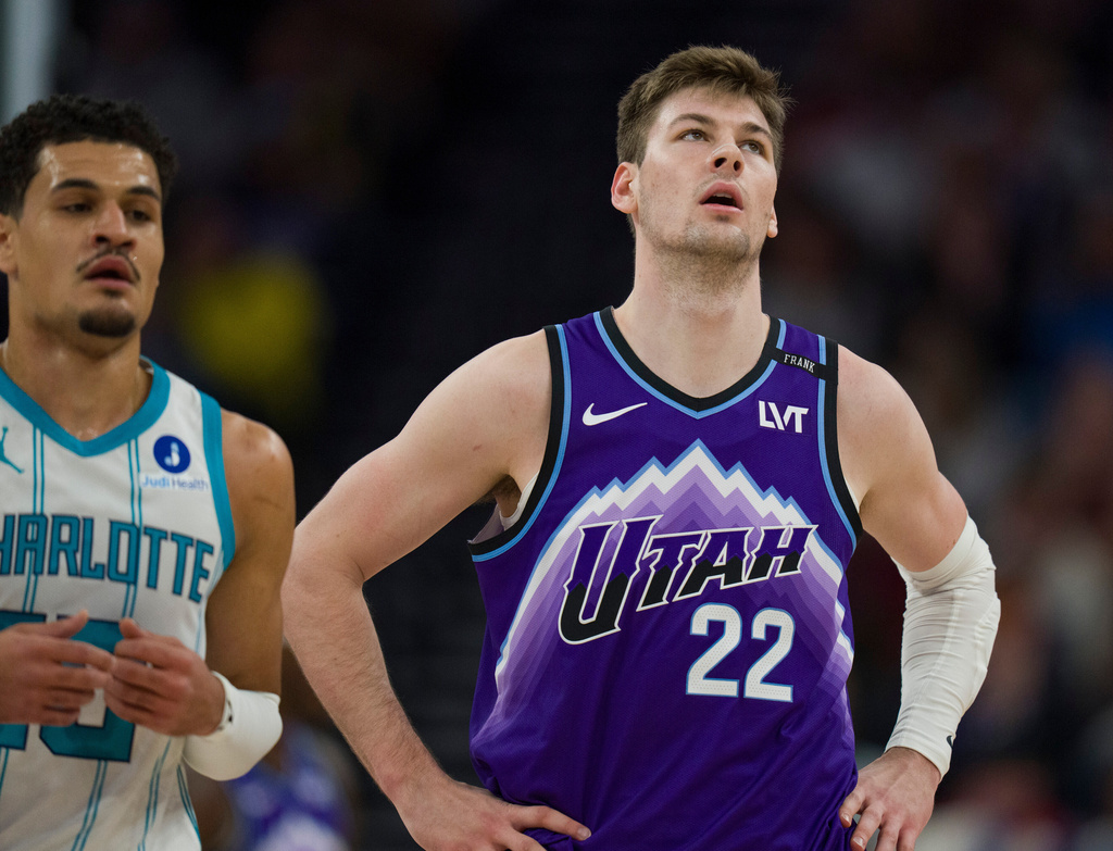 Utah Jazz center Kyle Filipowski (22) reacts as Charlotte Hornets guard Josh Green comes down the court during the first half of an NBA basketball game, Saturday, Jan. 10, 2026, in Salt Lake City. (AP Photo/Bethany Baker)