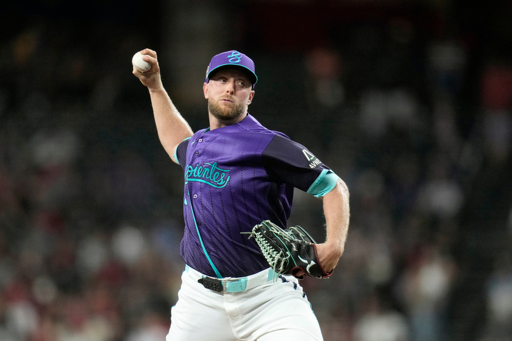 Arizona Diamondbacks starting pitcher Merrill Kelly throws against the Texas Rangers during the first inning of a baseball game, Friday, Sept. 11, 2026, in Phoenix. (AP Photo/Ross D. Franklin)