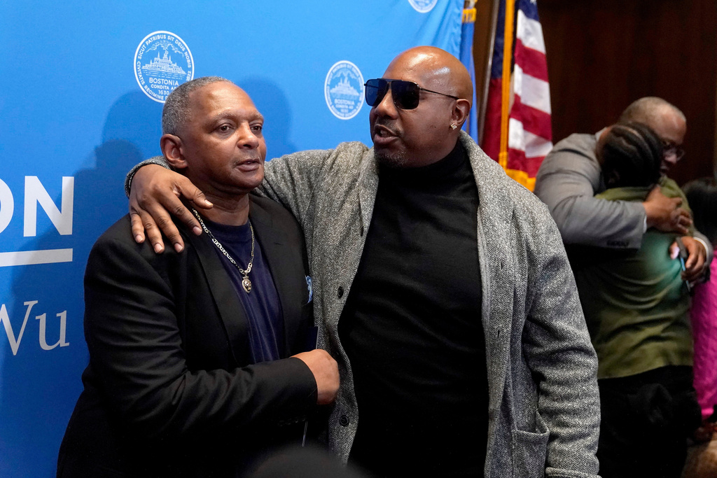FILE - Alan Swanson, left, is embraced by Joseph Bennett, nephew of Willie Bennett, center, following a news conference Wednesday, Dec. 20, 2023, in Boston. (AP Photo/Steven Senne, File)