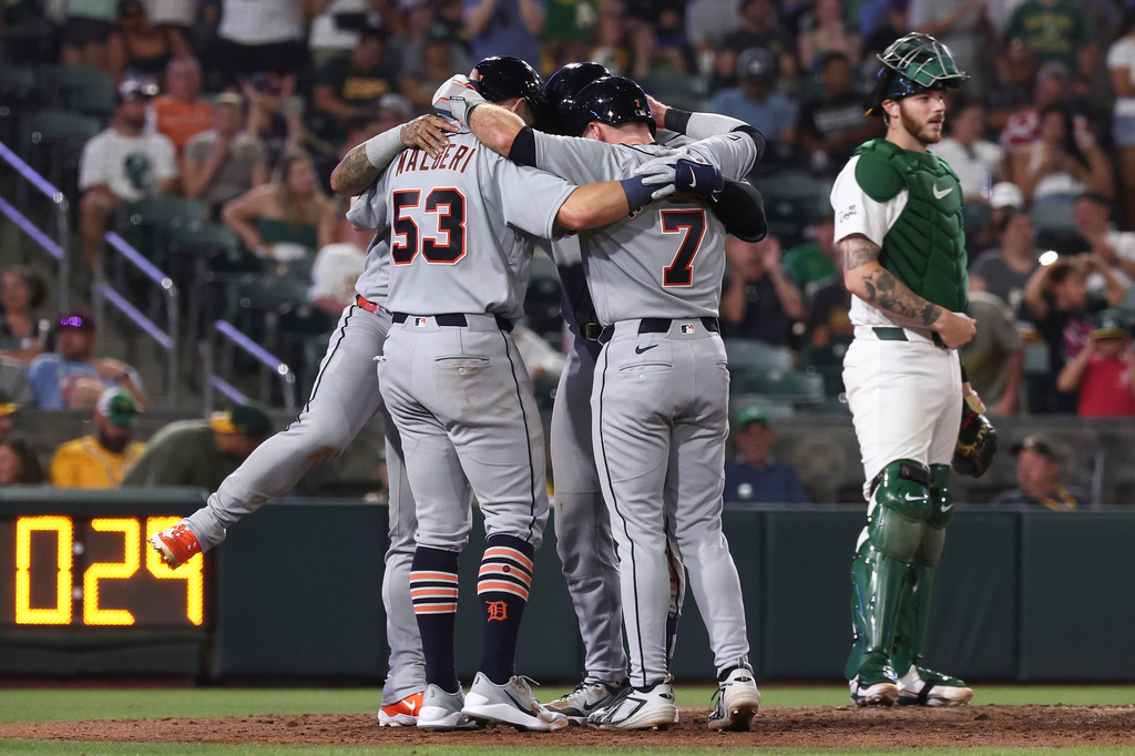 Detroit Tigers' Dillon Dingler, not shown, celebrates with Ben Malgeri (53), Kevin McGonigle (7), and Javier Báez, not shown, after hitting a grand slam during the eighth inning of a baseball game against the Athletics, Friday, July 31, 2026, in West Sacramento, Calif. (AP Photo/Sara Nevis)