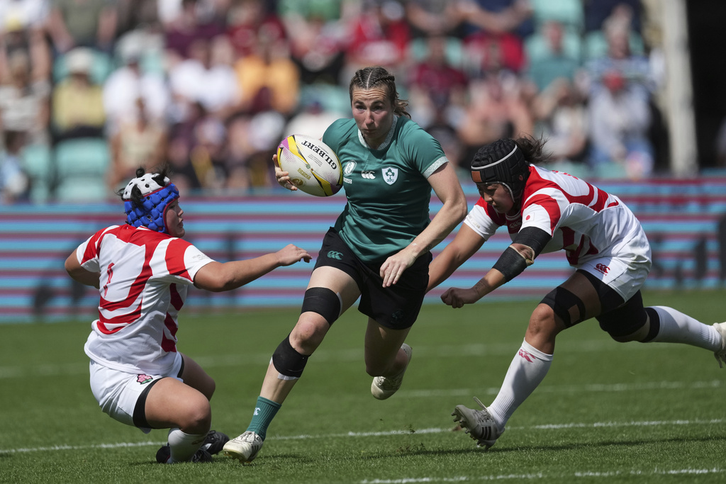 Ireland's Eve Higgins, evades a tackle during the group C match between Ireland and Japan of the 2025 Women's Rugby World Cup, in Northampton, England, Sunday, Aug. 24, 2025. (AP Photo/Dave Shopland)