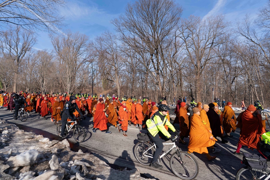 Buddhist monks who are participating in a Walk For Peace walk through a the streets of Washington, Tuesday, Feb. 10, 2026. (AP Photo/Jose Luis Magana)
