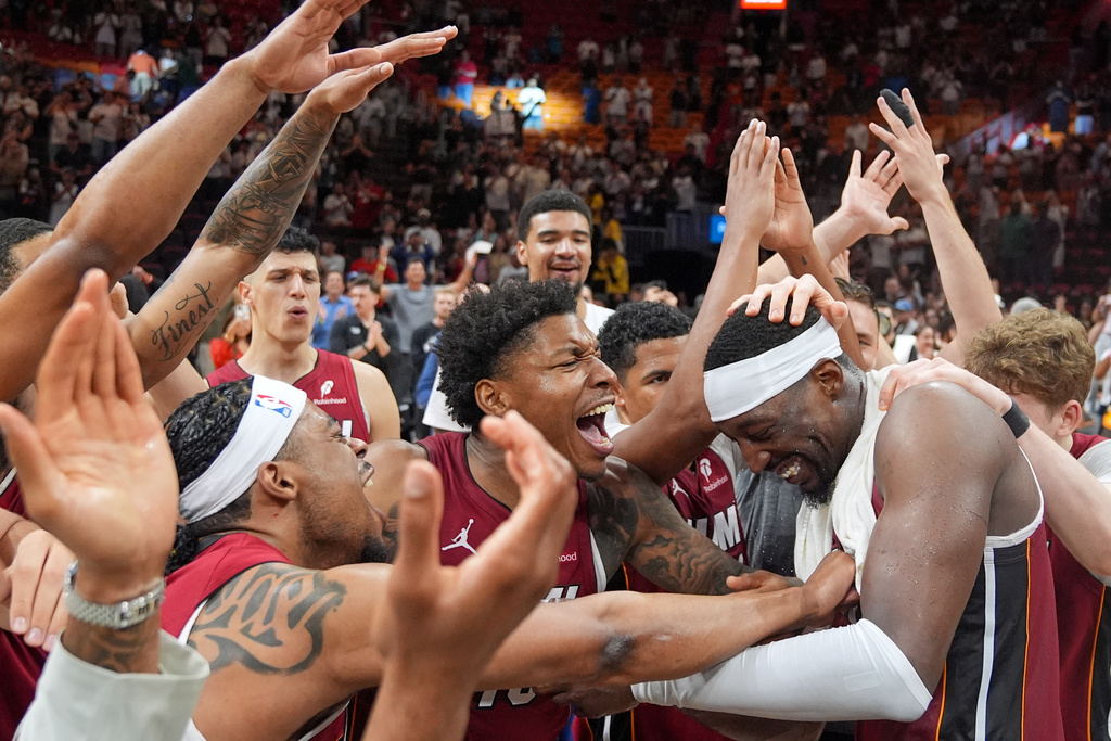 Miami Heat teammates celebrate center Bam Adebayo, right, after he scored 83 points, the second-highest single game total in NBA history, in an NBA basketball game against the Washington Wizards, Tuesday, March 10, 2026, in Miami. (AP Photo/Rebecca Blackwell)