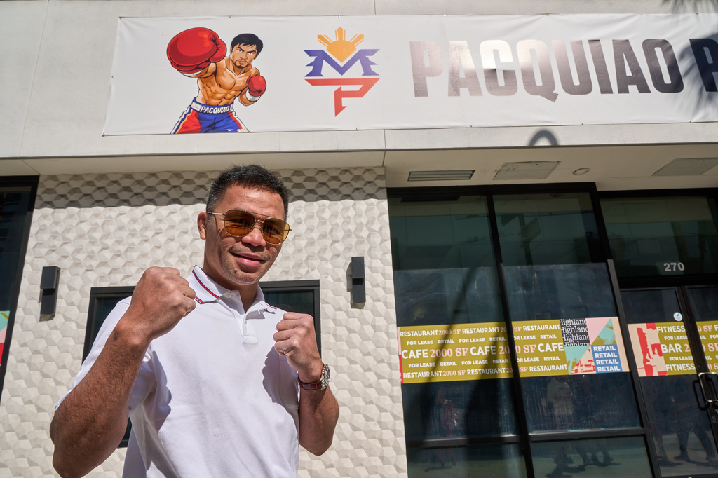 Boxer Manny Pacquiao pauses for a picture outside his "Pacquiao Prime Boxing," his newly acquired gym in Hollywood, on Monday, April 6, 2026. The facility was formerly owned by rival Floyd Mayweather Jr. (AP Photo/Damian Dovarganes)