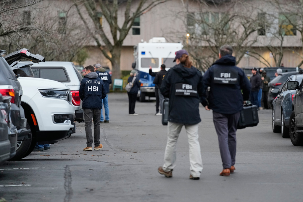 Law enforcement officials work the scene following reports that federal immigration officers shot and wounded people in Portland, Ore., Thursday, Jan. 8, 2026. (AP Photo/Jenny Kane)