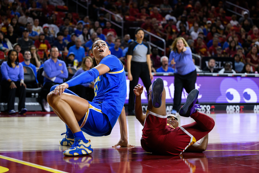 UCLA center Lauren Betts, left, looks up after a collision with Southern California guard Londynn Jones during the first half of an NCAA college basketball game Sunday, March 1, 2026, in Los Angeles. (AP Photo/William Liang)
