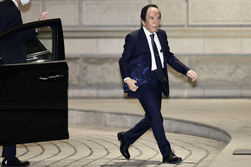The Bank of Japan (BOJ) Gov. Kazuo Ueda arrives at the headquarters of BOJ in Tokyo, Friday, Dec. 19, 2025. (Kyodo News via AP)