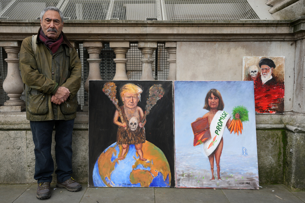 Artist Kaya Mar poses with his newest painting edition for photographers outside Downing Street before Britain's Chancellor of the Exchequer Rachel Reeves leaves to deliver the Spring Statement in London, Tuesday, March 3, 2026.(AP Photo/Kin Cheung)