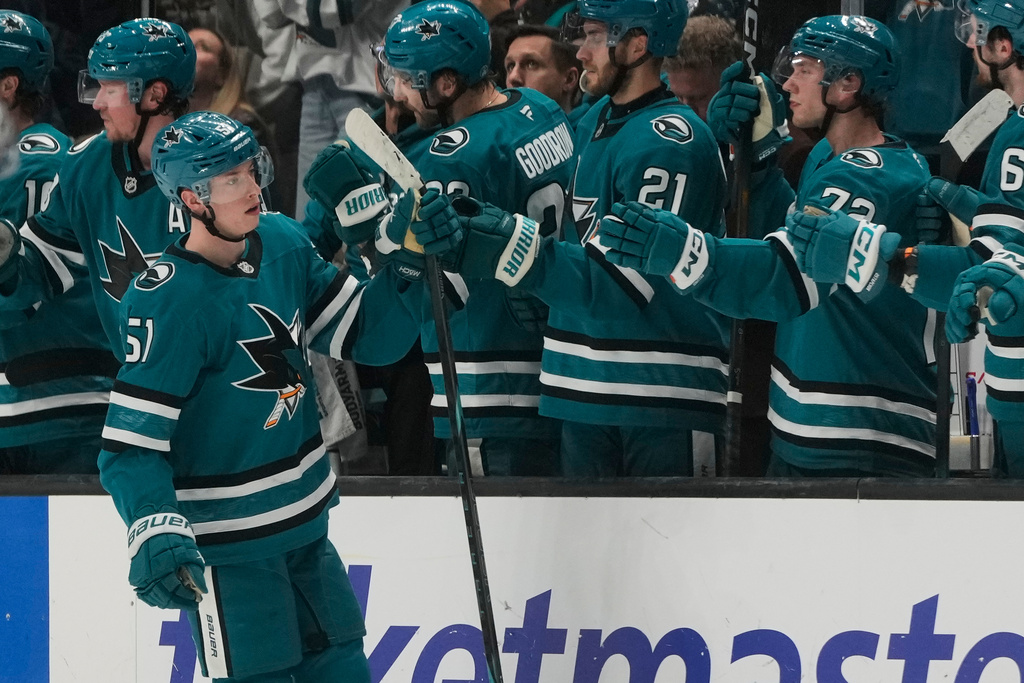 San Jose Sharks right wing Collin Graf (51) is congratulated by teammates after scoring against the Dallas Stars during the second period of an NHL hockey game in San Jose, Calif., Thursday, Dec. 18, 2025. (AP Photo/Jeff Chiu)