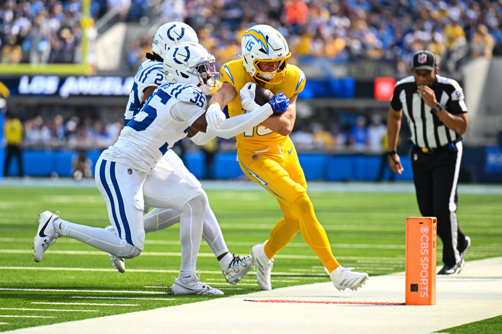 Los Angeles Chargers wide receiver Ladd McConkey (15) is pushed out of bounds by Indianapolis Colts cornerback Johnathan Edwards (35) during the first half of an NFL football game Sunday, Oct. 19, 2025, in Inglewood, Calif. (AP Photo/Carrie Giordano)