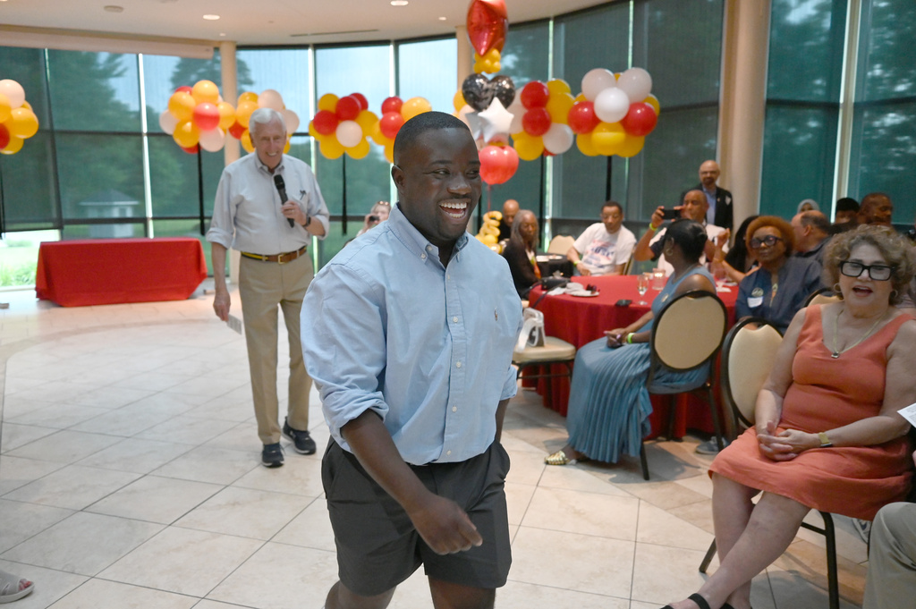 Adrian Boafo, a Maryland state delegate and candidate for U.S. Congress walks into the crowd after being introduced by Congressman Steny Hoyer, left, at the "AmeriPac Bull Roast" Friday, June 12, 2026, in Mitchellville, Md. (AP Photo/Gail Burton)