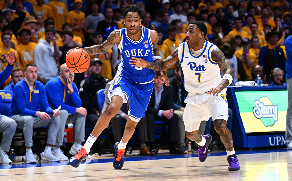 Duke's Isaiah Evans dribbles as Pittsburgh's Damarco Minor (7) defends in the first half of an NCAA college basketball game in Pittsburgh, Tuesday, Feb. 10, 2026. (AP Photo/Justin Berl)