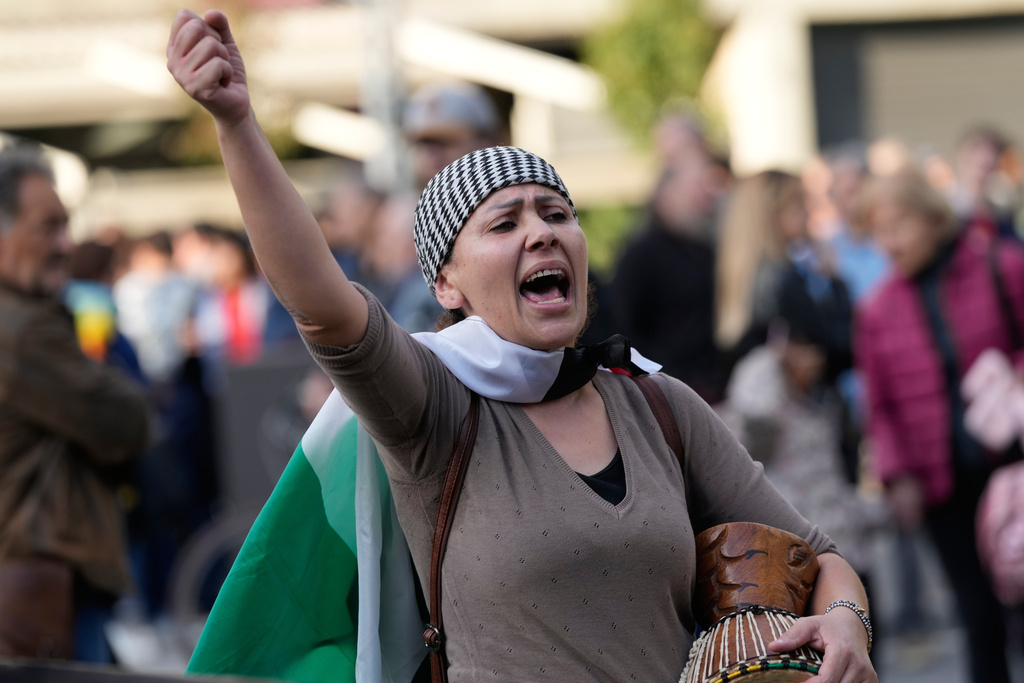 FILE -A woman protests against the participation of the Israeli national team in the 2026 Soccer World Cup qualification match against Italy being played in the evening in Udine, Italy, Oct. 14, 2025. (AP Photo/Luca Bruno, File)
