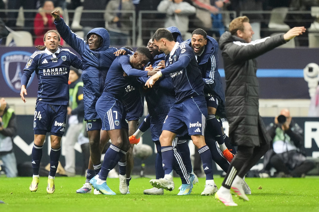 Paris FC's Alimami Gory, centre left, celebrates with teammates after scoring his side's second goal during the French League One soccer match between Paris FC and Paris Saint-Germain in Paris, Sunday, May 17, 2026. (AP Photo/Michel Euler)