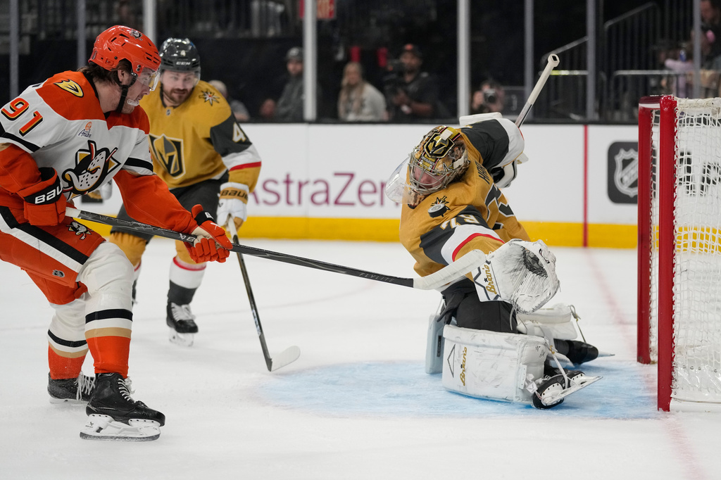 Anaheim Ducks center Leo Carlsson (91) attempts to shoot past Vegas Golden Knights goaltender Carter Hart (79) during the first period of Game 1 of a second-round NHL hockey Stanley Cup playoff series Monday, May 4, 2026, in Las Vegas. (AP Photo/John Locher)