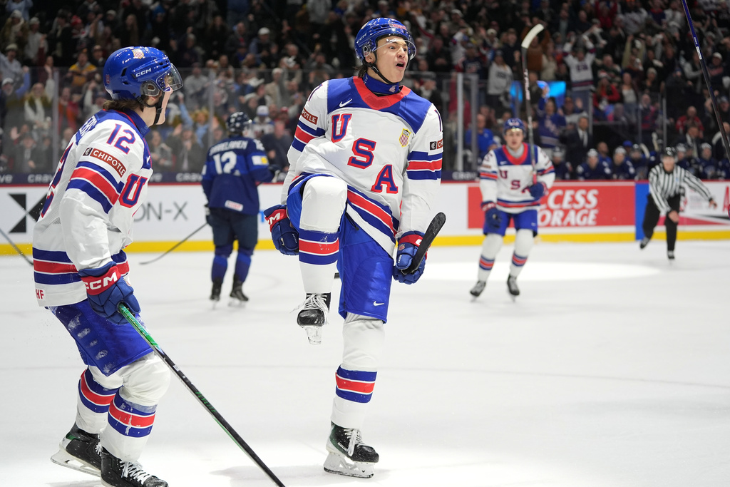 United States forward Ryker Lee, front right, celebrates after scoring during the third period of an IIHF World Junior Hockey Championship quarterfinals game against Finland, Friday, Jan. 2, 2026, in St. Paul, Minn. (AP Photo/Abbie Parr)