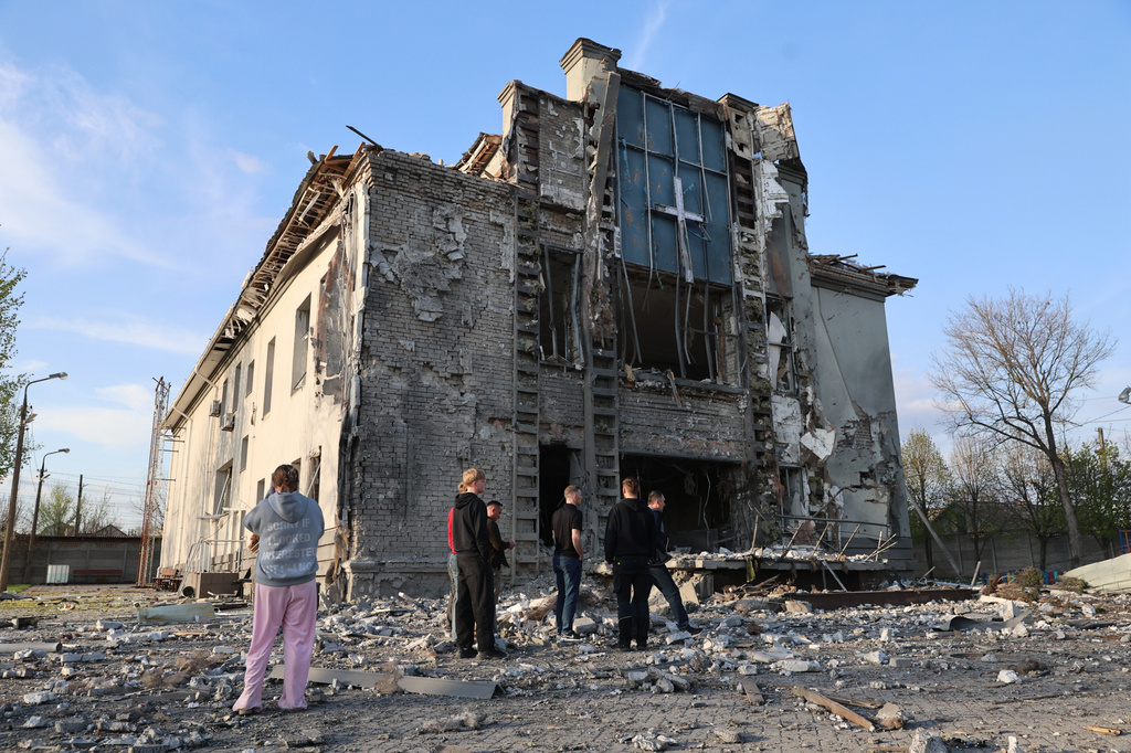 People stand outside a Baptist church damaged by a Russian guided aerial bomb, in Zaporizhzhia, Ukraine, Thursday, April 16, 2026. (AP Photo/Kateryna Klochko)
