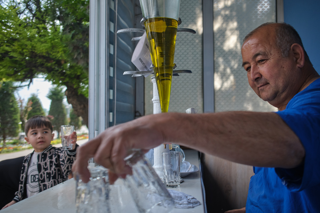 A vendor sells soda in Panjakent, Tajikistan, Monday, May 4, 2026. (AP Photo/Jon Orbach)