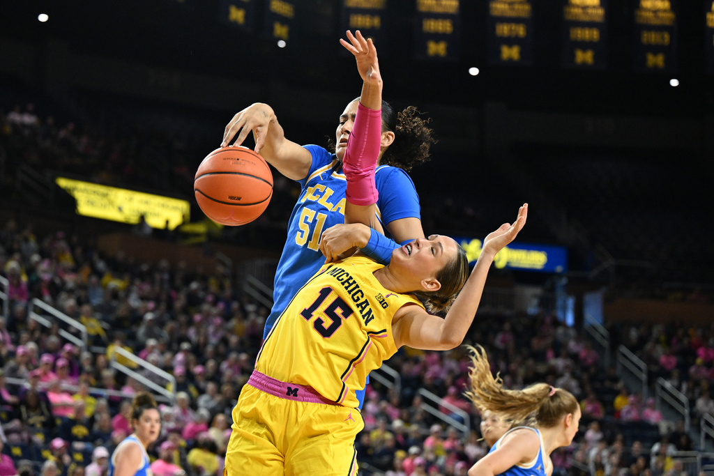 UCLA center Lauren Betts (51) battles for a rebound with Michigan forward Ashley Sofilkanich (15) in the first half of an NCAA college basketball game in Ann Arbor, Mich., Sunday, Feb. 8, 2026. (AP Photo/Lon Horwedel)