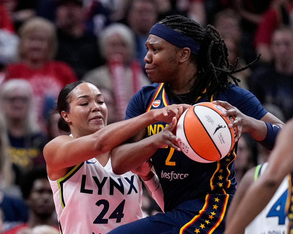 Minnesota Lynx forward Napheesa Collier (24) fouls Indiana Fever forward Myisha Hines-Allen, right, in the first half of a WNBA basketball game in Indianapolis, Tuesday, Sept. 22, 2026. (AP Photo/Michael Conroy)