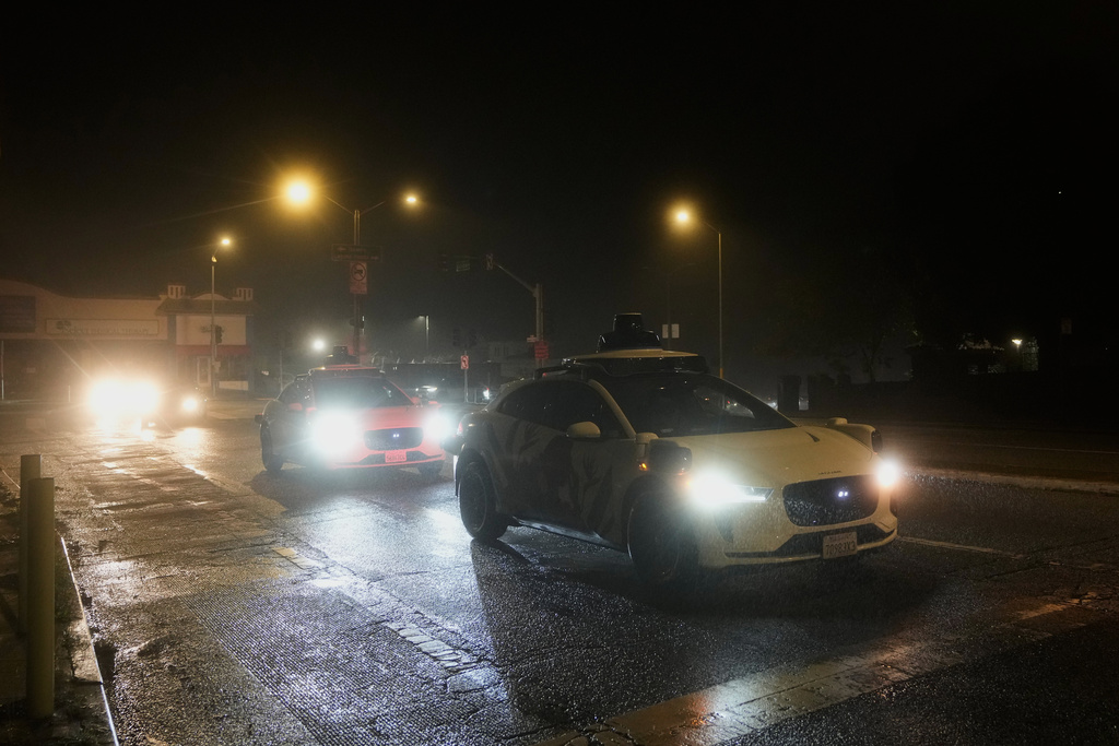 A Waymo vehicle sits idling at an intersection with no operating traffic lights due to power outages, in San Francisco, Saturday, Dec. 20, 2025. (AP Photo/Jeff Chiu)