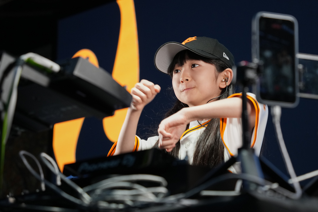 Nine-year-old DJ Rinoka performs at Tokyo Dome before a Yomiuri Giants baseball game on May 24, 2026, in Tokyo. (AP Photo/Eugene Hoshiko)