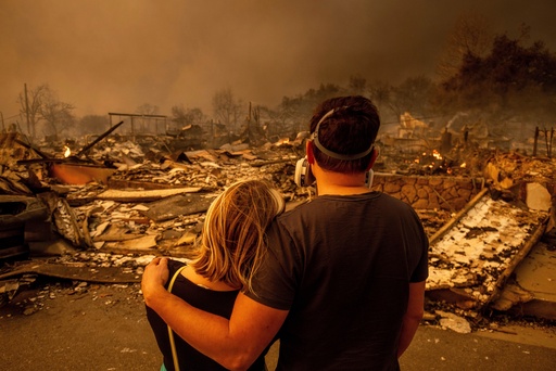 FILE - Megan Mantia, left, and her boyfriend Thomas, return to Mantia's fire-damaged home after the Eaton Fire swept through, Jan. 8, 2025 in Altadena, Calif. (AP Photo/Ethan Swope, File) FILE - Megan Mantia, left, and her boyfriend Thomas, return to Mantia's fire-damaged home after the Eaton Fire swept through, Jan. 8, 2025 in Altadena, Calif. (AP Photo/Ethan Swope, File)