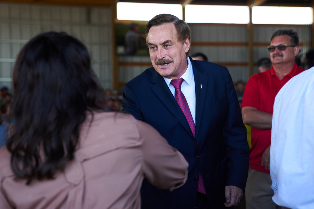 Mike Lindell, gubernatorial candidate, greets Minnesota House Speaker Lisa Demuth, who he will face in the Republican primary, as they arrive to take part in a Minnesota Governor Candidate Forum in Morgan, Minn., Wednesday, Aug. 5, 2026. (AP Photo/Ellen Schmidt)