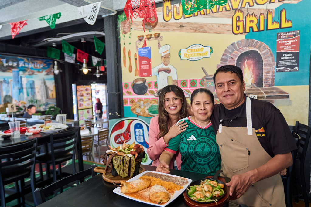 Chef Marco Mendoza, right, his wife Maria Luisa Mendoza, center, and daughter Nayomie Mendoza, pose for a picture at their Mexican restaurant Cuernavaca's Grill in downtown Los Angeles, Tuesday, April 28, 2026. (AP Photo/Damian Dovarganes)