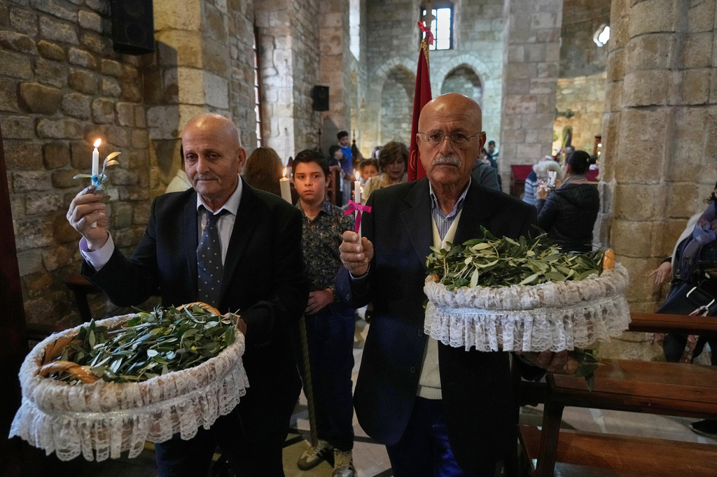 Worshipers attend Palm Sunday Mass procession at Saint Thomas Cathedral, in the southern port city of Tyre, south Lebanon, Sunday, March 29, 2026. (AP Photo/Hussein Malla)
