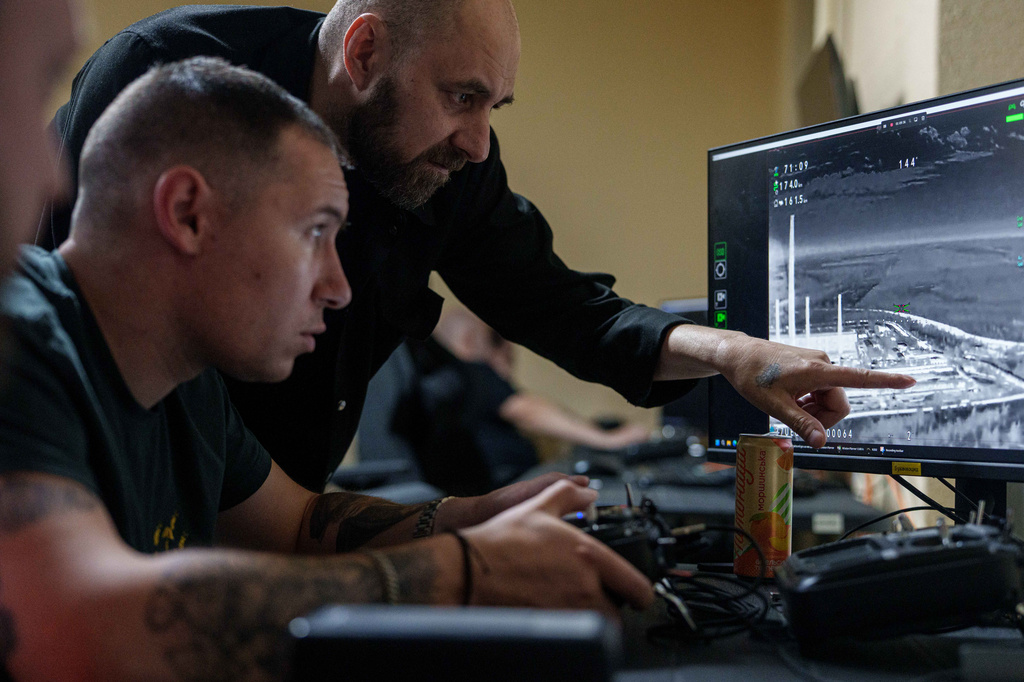 A Ukrainian serviceman of K-2 brigade of the Unmanned Systems Forces operates a midrange drone during a flight towards Russian positions at the frontline, at a command center in undisclosed location, Ukraine, Sunday, June 21, 2026. (AP Photo/Evgeniy Maloletka)