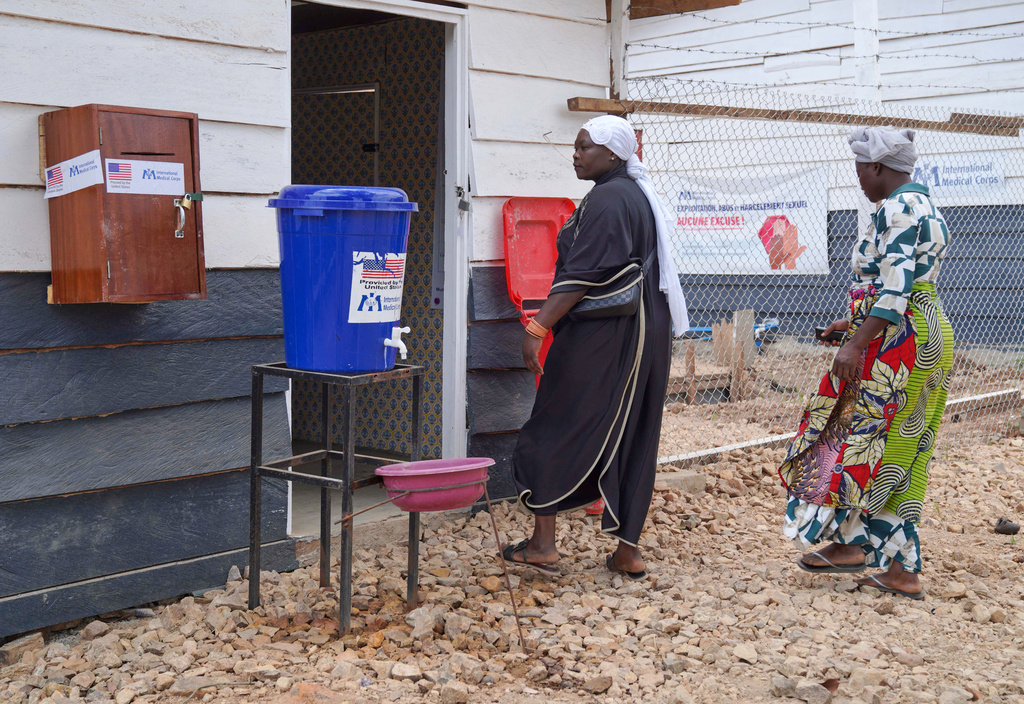 Family members of Abineno Justine, a 38 year old woman who died of the Ebola virus, arrive at a morgue to identify her body ahead of her burial, in Bunia, Congo, Friday, Sept. 4, 2026. (AP Photo/Dieudonne Dirole)