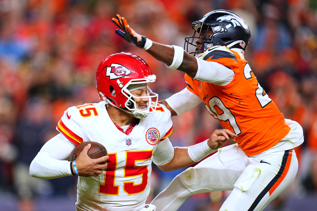 Denver Broncos cornerback Ja'Quan McMillian, right, sacks Kansas City Chiefs quarterback Patrick Mahomes (15) during the second half an NFL football game Sunday, Nov. 16, 2025, in Denver. (AP Photo/Jack Dempsey)