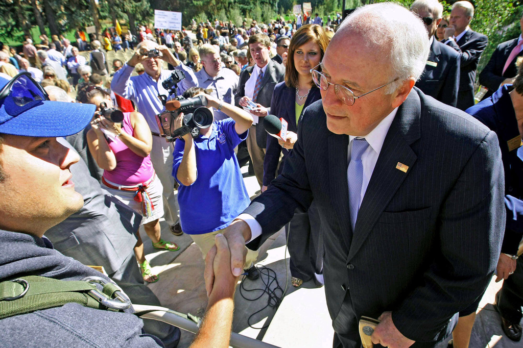 FILE - Former Vice President Dick Cheney, right, shakes hands with Iraqi War veteran Peter Howard on Sept. 10, 2009, in Laramie, Wyo. (Andy Carpenean/Laramie Boomerang via AP, File)