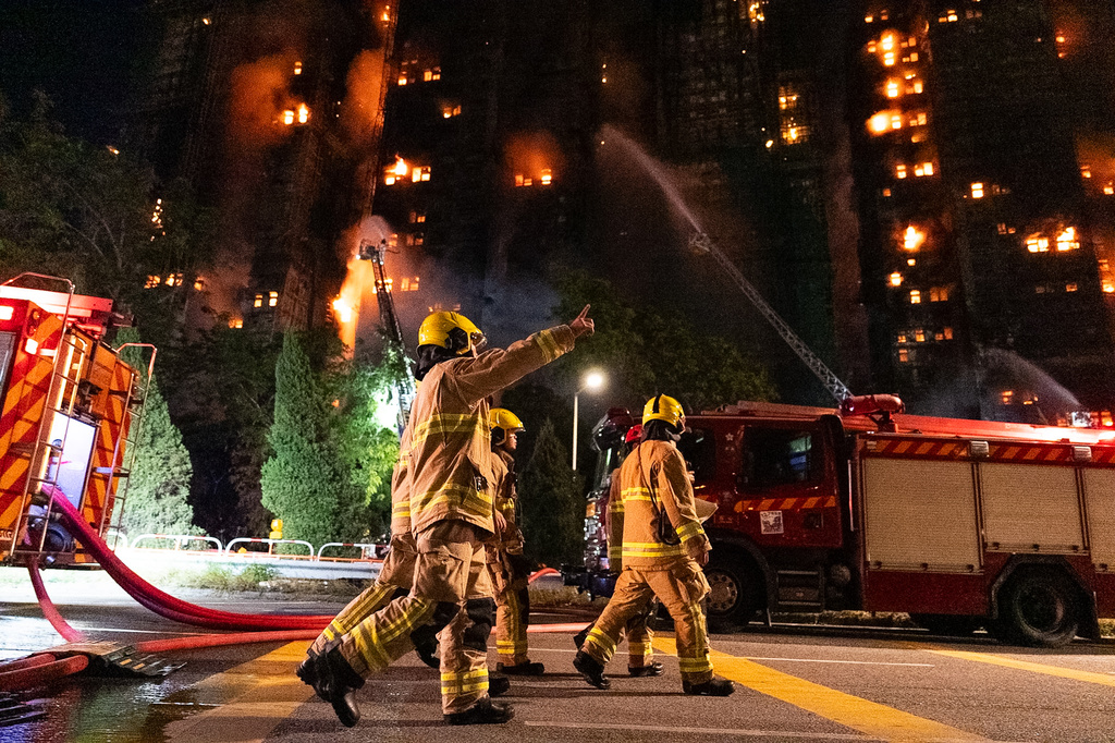 Firefighters work to extinguisha fire that broke out at Wang Fuk Court, a residential estate in the Tai Po district of Hong Kong's New Territories, Wednesday, Nov. 26 2025. (AP Photo/Chan Long Hei)