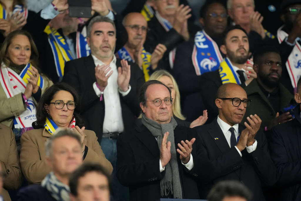Former French President Francois Hollande applauds from the stands during a World Cup 2026 group D qualifying soccer match between France and Ukraine in Paris, Thursday, Nov. 13, 2025. (AP Photo/Christophe Ena)
