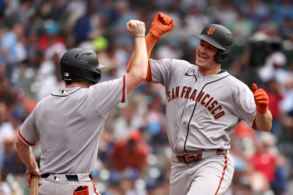 San Francisco Giants' Matt Chapman, right, celebrates with the Giants bat boy Carter Pierce after hitting a three-run home run, his second home run of the baseball game, in the sixth inning against the Chicago Cubs at Wrigley Field, Friday, June 5, 2026, in Chicago. (AP Photo/Geoff Stellfox)
