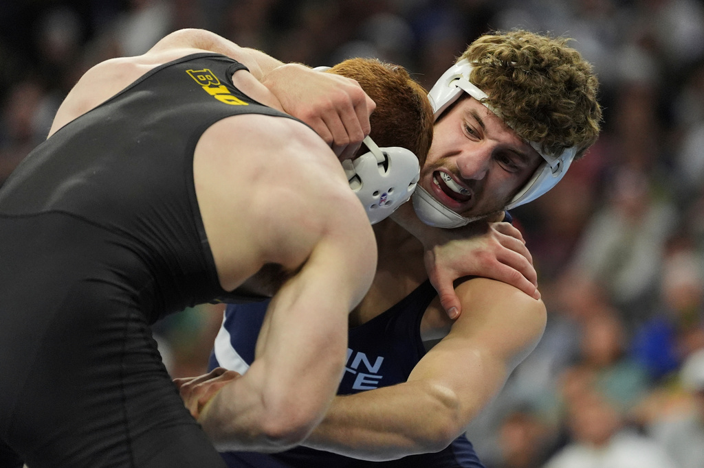 FILE - Penn State's Mitchell Mesenbrink, right, takes on Iowa's Mike Caliendo in their 165-pound match in the finals at the NCAA wrestling championship, March 22, 2025, in Philadelphia. (AP Photo/Matt Rourke, File)